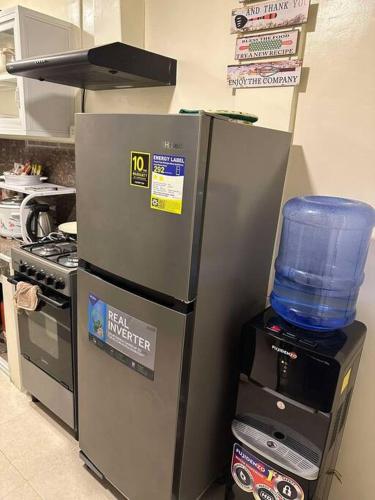 a refrigerator in a kitchen next to a stove at Sunny Villa in Angeles