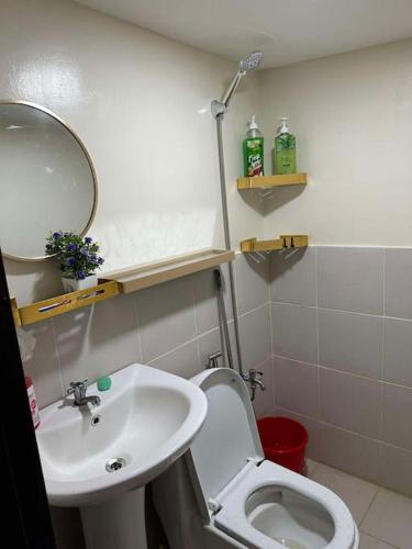 a bathroom with a sink and a toilet and a mirror at Sunny Villa in Angeles