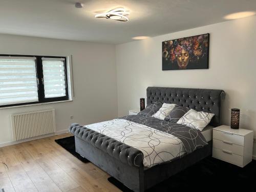 a bedroom with a large bed with a leather headboard at Greenview Apartment Trier - 3 beds 2 bedrooms in Trier