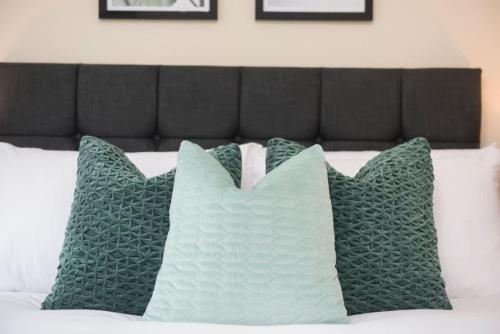 a group of pillows sitting on top of a bed at Wilson House - Camden in London