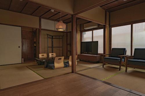 a living room with chairs and a flat screen tv at CraftFlat Asakusa House, Space to Live, Laugh, and Feel at Home in Tokyo