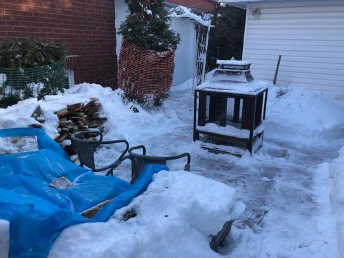 a yard covered in snow with a house at La maison de Gabriel in Quebec City