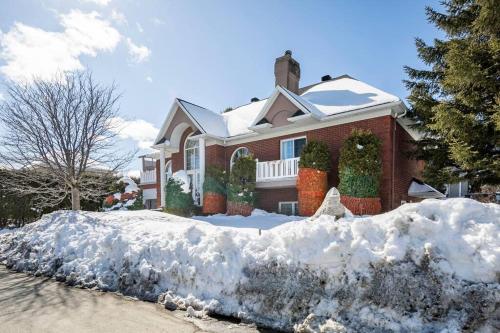 a house with a pile of snow in front of it at La maison de Gabriel in Quebec City