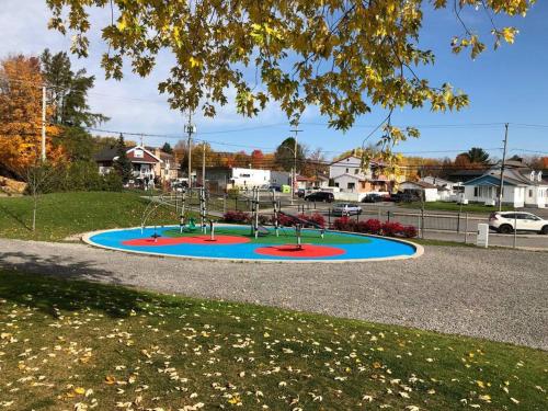 a playground in a park with a playground at La maison de Gabriel in Quebec City