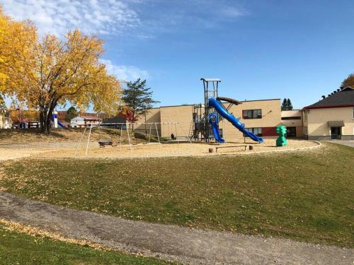 a playground with a blue slide in a park at La maison de Gabriel in Quebec City