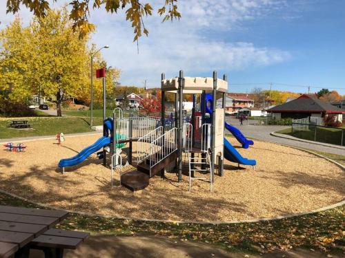 a playground with a slide in a park at La maison de Gabriel in Quebec City
