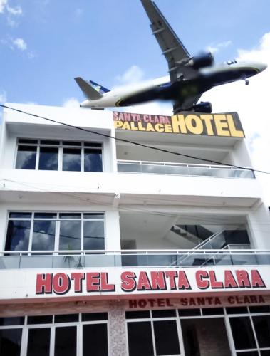a plane is flying over a hotel santa clara at Hotel Santa Clara in Belém