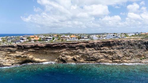 a view of the ocean from a cliff at Artiko Luxury Suites - Jan Thiel in Jan Thiel
