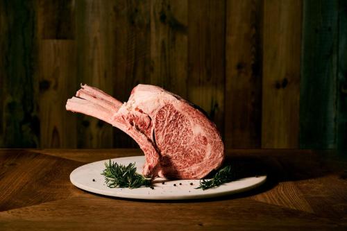 a piece of meat sitting on a plate on a table at samana hotel Yakushima in Yakushima