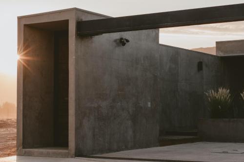 a building with an open door in the desert at Casa Malbec, Valle de Guadalupe in Valle de Guadalupe