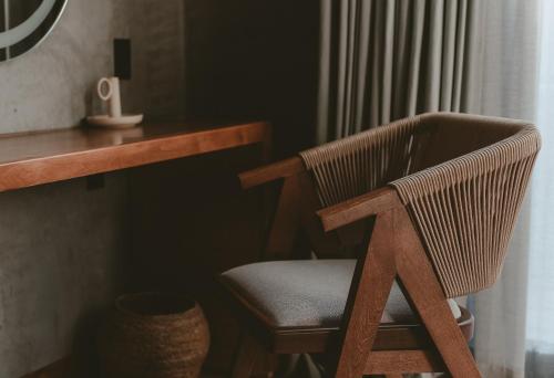 a wooden chair sitting in front of a desk at Casa Malbec, Valle de Guadalupe in Valle de Guadalupe