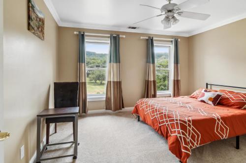 a bedroom with a bed and a ceiling fan at Country Cove in Brentwood