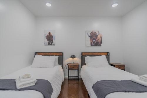two twin beds sitting next to each other in a room at The Executive Southernwind Suite 2.0 in Fairbanks