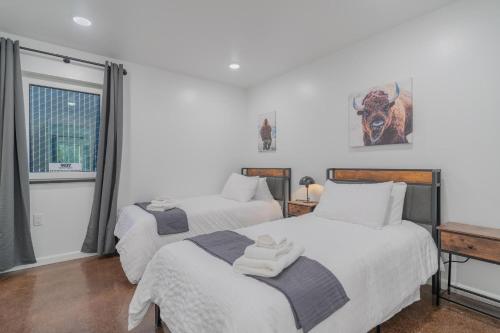 a bedroom with two beds and a window at The Executive Southernwind Suite 2.0 in Fairbanks