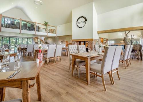 a dining room with wooden tables and chairs at Beaconsfield Park in Shrewsbury
