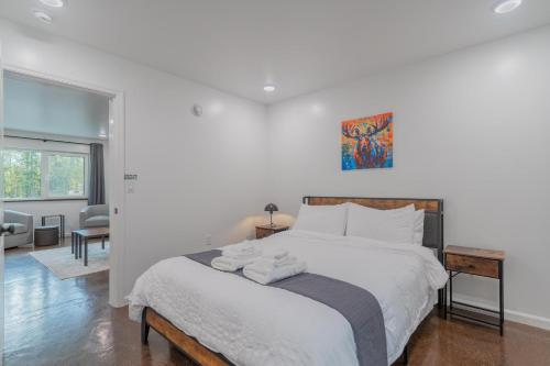 a bedroom with a bed with two towels on it at The Pet Friendly Executive Northernwind Suite 1.0 in Fairbanks