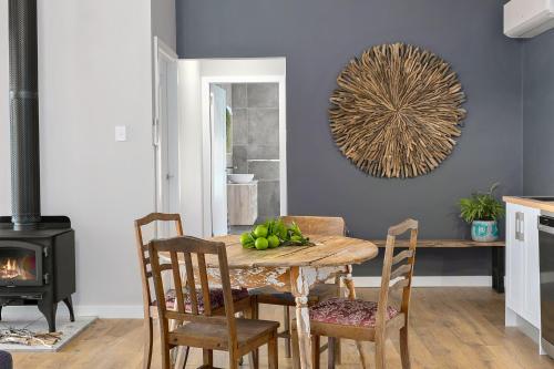 a dining room with a table with fruit on it at Skyfarm in Kurrajong
