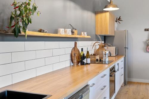 a kitchen with a counter top with bottles of wine at Skyfarm in Kurrajong