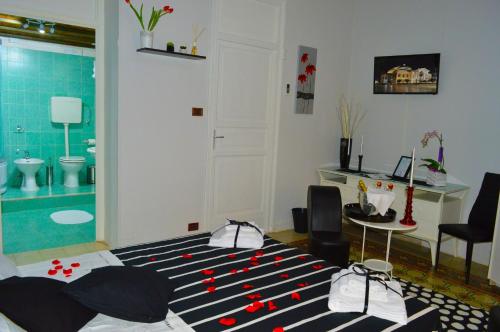 a room with a bathroom with a bed and a table at Alba Camere in Palermo