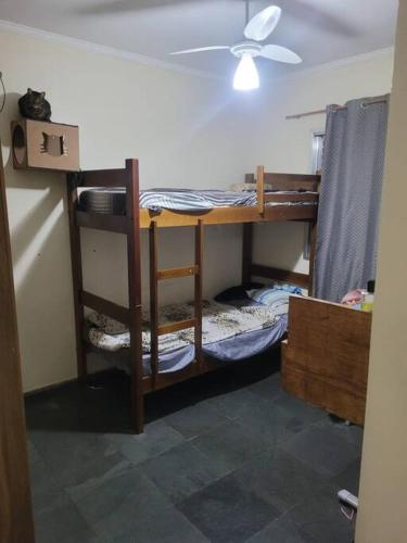 a room with bunk beds with a ceiling fan at Casa Tomazella in Guarujá