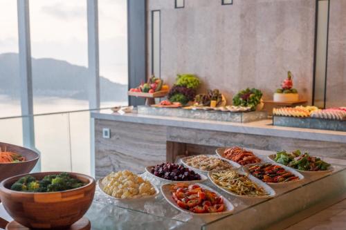a buffet line with many different types of food at Grand Hyams Hotel - Quy Nhon Beach in Quy Nhon