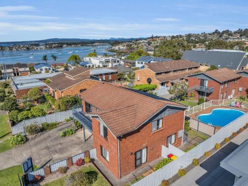 an aerial view of a brick house with a pool at Harbour Lights - townside with a pool in Merimbula