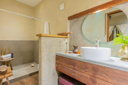 a bathroom with a sink and a mirror at Aruma Villa Boutique Isla Mujeres with beach club access included in Isla Mujeres