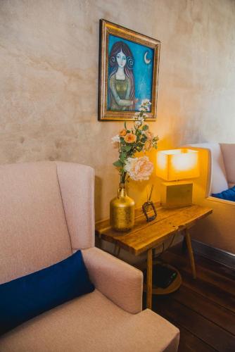a room with a couch and a table with a painting at Aruma Villa Boutique Isla Mujeres with beach club access included in Isla Mujeres