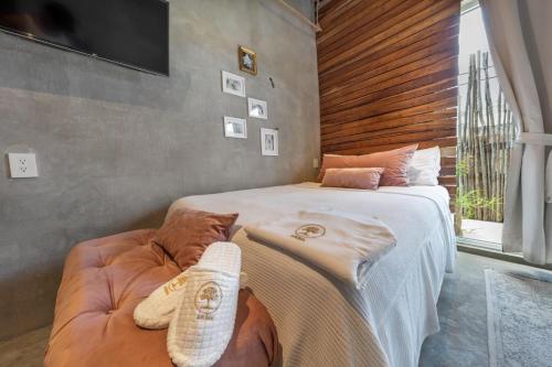 a bedroom with a large bed and a couch at Aruma Villa Boutique Isla Mujeres with beach club access included in Isla Mujeres