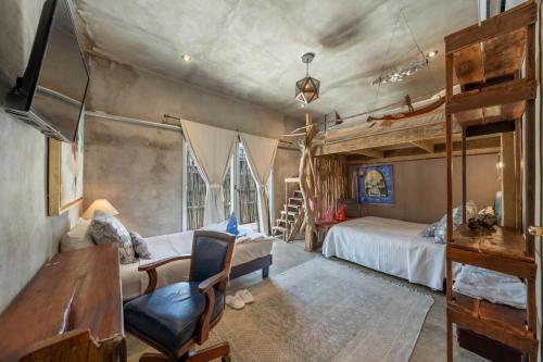 a bedroom with a bunk bed and a ladder at Aruma Villa Boutique Isla Mujeres with beach club access included in Isla Mujeres