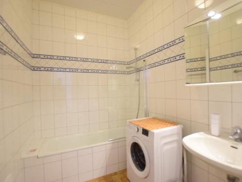 une salle de bain blanche avec une machine à laver à l'intérieur dans l'établissement Bel appartement proche thermes avec balcon et animaux admis - FR-1-498-106, à Évian-les-Bains