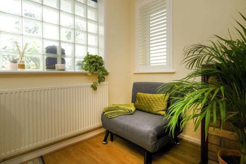 a living room with a chair and a window at Wilson House - Camden in London