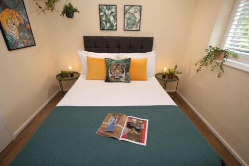 a bedroom with a bed with a book on it at Wilson House - Camden in London