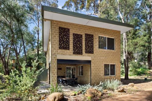 a house in the middle of a forest at River Tree Chalet - Margaret River NEW in Margaret River Town