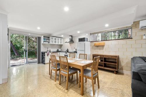 a kitchen and dining room with a table and chairs at River Tree Chalet - Margaret River NEW in Margaret River Town