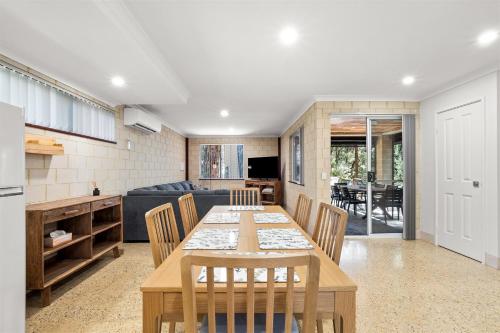 a kitchen and dining room with a table and chairs at River Tree Chalet - Margaret River NEW in Margaret River Town