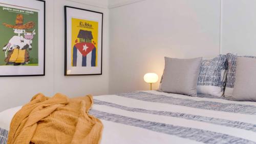 a bedroom with a bed and two posters on the wall at The Pines - Stylish, Brand new home in Mullumbimby