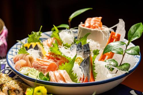 a bowl of food with sushi on a table at Marco Polo Xiamen in Xiamen
