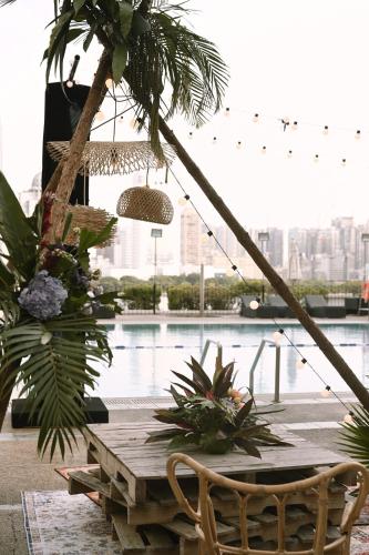 a wooden table with plants and a view of the city at Marco Polo Xiamen in Xiamen