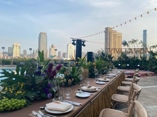 a long table with plates of food and flowers at Marco Polo Xiamen in Xiamen