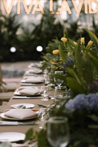 a long table with plates and wine glasses on it at Marco Polo Xiamen in Xiamen