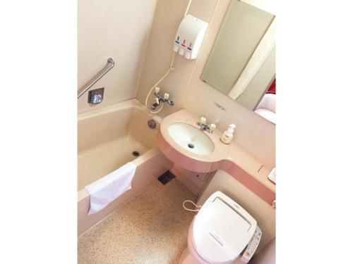 a bathroom with a sink and a toilet and a mirror at Nobeoka Urban-Hotel - Vacation STAY 30462v in Nobeoka