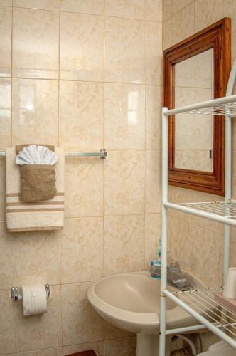 a bathroom with a sink and a mirror at Veronica Homestay Lucea Jamaica in Lucea