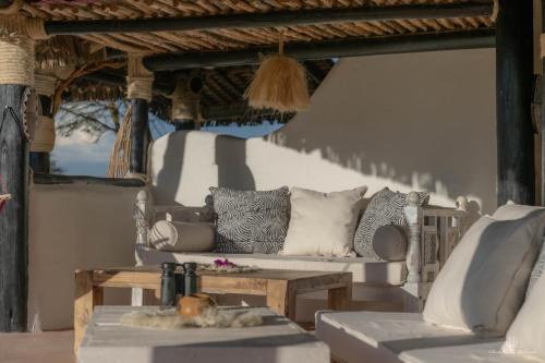 a living room with a couch and a table at Mara Major Camp in Masai Mara