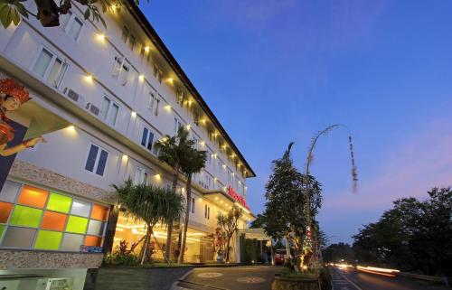 a large building with lights on the side of it at Mars City Hotel in Denpasar