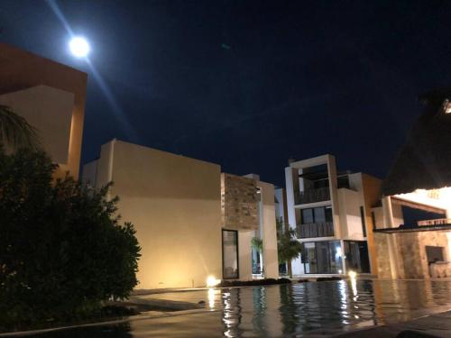 a group of buildings at night with a street light at Villa Nicte ha - Antalea in Telchac Puerto