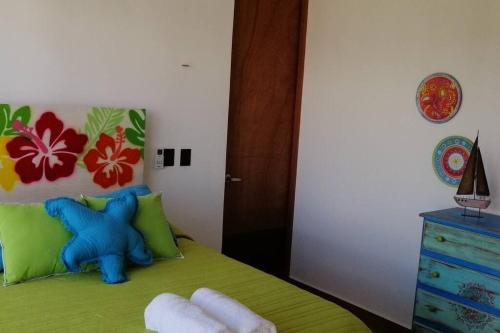 a childs bedroom with a teddy bear on a bed at Villa Nicte ha - Antalea in Telchac Puerto