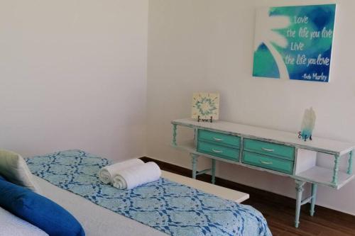a bedroom with a desk and a bed and a bed sidx sidx sidx at Villa Nicte ha - Antalea in Telchac Puerto
