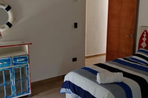a bedroom with a blue and white bed and a cabinet at Villa Nicte ha - Antalea in Telchac Puerto