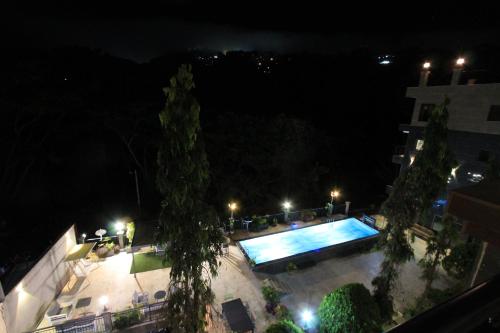a view of a pool at night at Residence MASSOU in Yaoundé